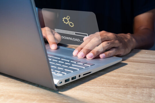 Man using laptop to download media or update software. Downloading process bar on virtual screen.