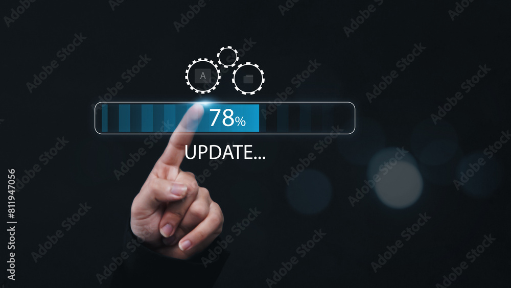 Fototapete Installing update system software for device operating systems to be up to date with the new version. Graphics icon showing updating function screen loading on computer, with businessman working.