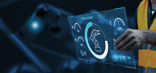 Engineer hand monitoring robotic AI arms in manufacturing factory plant, manager managing controlling using computer holographic ui display analysis technology, engineer, dark banner background.