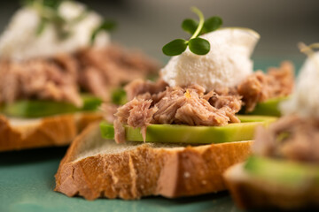 Toasts with canned tuna and avocado. Healthy food and diet breakfast