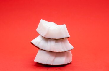 Coconut White Flesh Isolated on Red Background with Copy Space