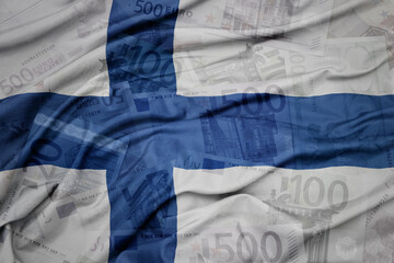 waving colorful national flag of finland on a euro money banknotes background. finance concept.