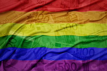 waving colorful rainbow gay flag on a euro money banknotes background. finance concept