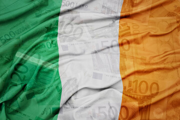 waving colorful national flag of ireland on a euro money banknotes background. finance concept.