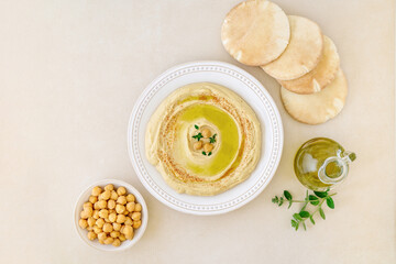 Hummus dip with chickpea, olives and pita bread . Top view