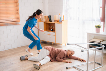caregiver support senior elderly patient who having accident to fall on the floor at home, health...