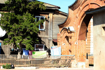 drying towels on a sunny summer afternoon in the courtyard of a wooden house with a spruce tree
