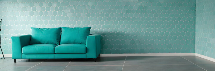 Modern interior of living room with grey sofa and cyan chairs on empty tile pattern wall background.