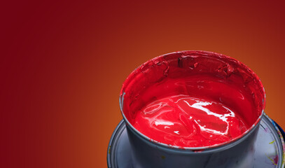 Red printing paint in a metal bucket. Industrial offset printing ink. Blank writing space on red...