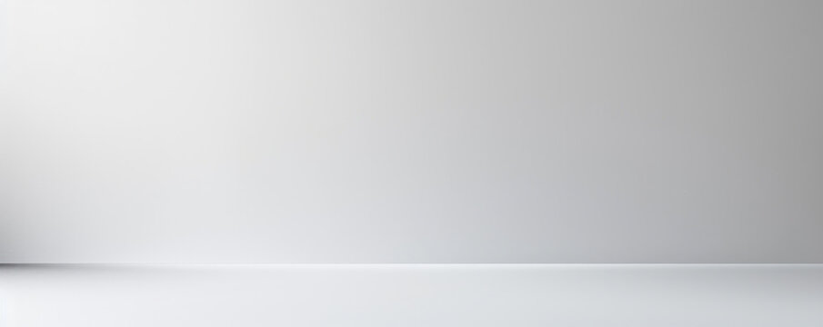 A white wall with a grey background. The wall is empty and has no decoration. The room is very plain and simple