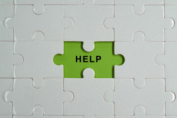 Piece of jigsaw puzzle with words HELP.