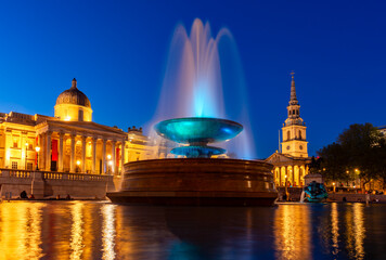 Fountain on Trafalgar square and National Gallery at sunset, London, UK