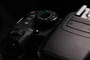 Photography shooting modes digital SLR camera with different buttons and roulettes nearby