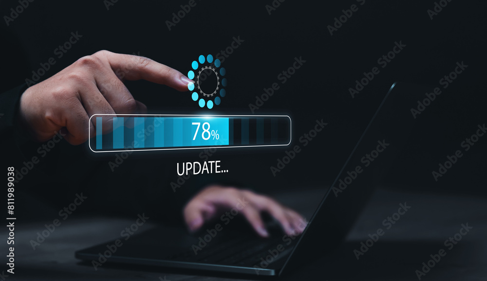 Fototapete Businessman updating computer system for device operating system to be up to date with new version. Graphics icon showing updating function screen loading on computer laptop.