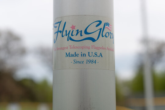 close-up of sticker on Flyin Glory "The Strongest Telescoping Flagpoles Available" Made in USA Since 1984 in the park