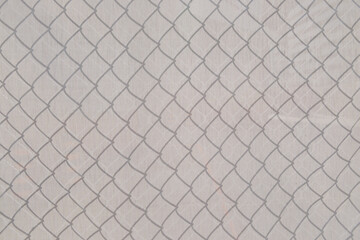 Fototapeta premium fabric background featuring shadow pattern of a chainlink fence