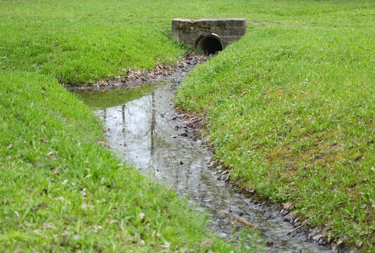 Drainage pipe connecting the ditch under the bridge in the Park
