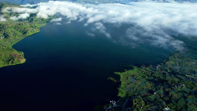 Establish Aerial View of the lake atas with a backdrop of Talang Mountain in Nagari Alahan Panjang, Solok Regency