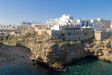 Polignano a Mare Famous Beach, Lama Monachile, famous beach in seaside city in Bari, Puglia, Italy. European summer.