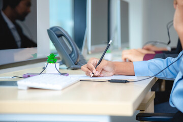 Close up of professional operator support center or call center is working in a office with...