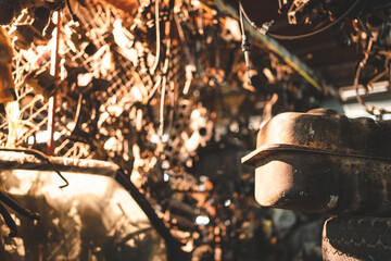 An Old and Dirty rusty steel machine in a garage, defocused vintage abstract textured background, old style of car industry, factory or manufacturing, metallic and iron rod, brown and black banner.