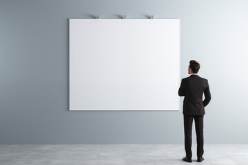 Fototapeta premium Businessman in front of empty work board