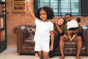 Happy African American Family at Home: Mother and Father Hug Their Young Daughter and Son, Sharing...