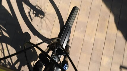 Bicycle wheel in motion. First-person perspective shot of a bicycle wheel in motion, showcasing urban cycling, perfect for sports and leisure concepts