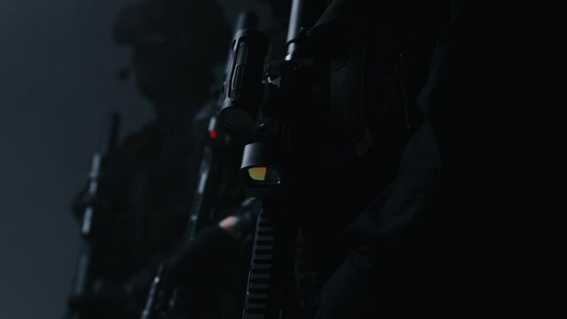 A squad of special forces armed with AR-15 rifles, fully equipped and prepared for a combat mission.