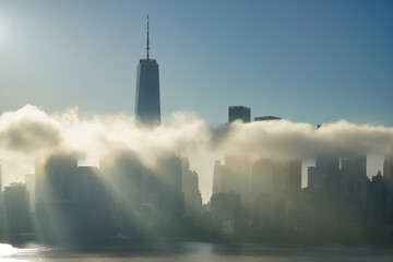 The rays of the rising sun break through the clouds over New York.