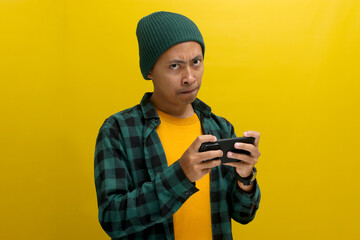 Bored Asian man, wearing a beanie hat and casual shirt, appears bored as he watches an...