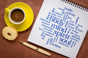 body, mind, spirit and soul word cloud - writing in a spiral notebook with coffee