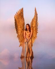 Split golden angel on pink lake