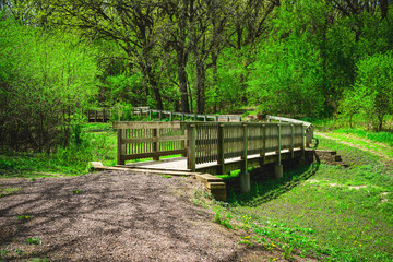 Great Bear Ski Valley with wooden footbridge in the green forest in Sioux Falls, South Dakota, USA