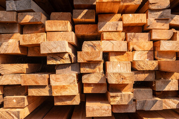 Wooden planks stacked on each other, construction building wood works concept, background texture.