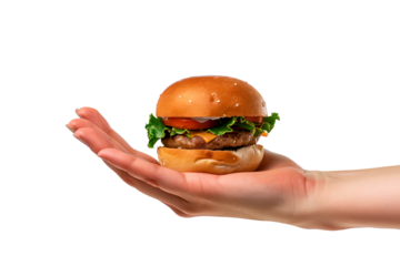 A burger in hand isolated on a white or transparent background. Close-up of a burger in hand, side view. Unhealthy consumption of fast food. Fast food photography.
