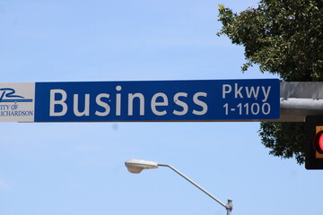 A street sign with a Business name.  It fits the complex were many small businesses have offices...