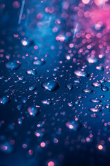 Enchanting Rainfall at Night: A Mystical Display of Light and Water