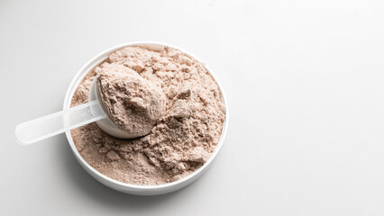 Whey protein powder in measuring scoop