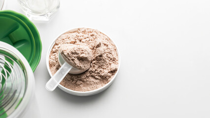 Whey protein powder in measuring scoop