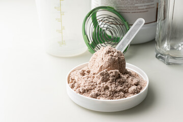 Whey protein powder in measuring scoop