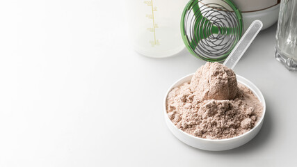 Whey protein powder in measuring scoop