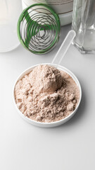 Whey protein powder in measuring scoop