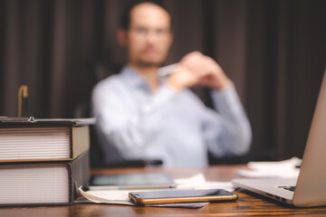 A table or desk full of business equipments, laptop, mobile phone, document and stationary, concept...