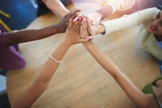 Teamwork, hands and above of business people on table in office for collaboration, community and agreement. Startup company, diversity and men and women for meeting, support and team building