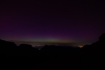 A beautiful green and red aurora borealis dancing over the swiss alps in the heart of Switzerland during a big sunstorm.