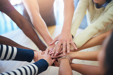 Teamwork, hands stack and business people on table in office for collaboration, community and...