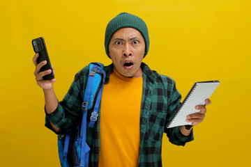 Asian student, dressed in a beanie hat and casual shirt and carrying a backpack, looks shocked...