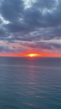 4k video of sunrise at sea. Video in vertical format.