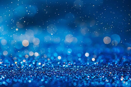 A shiny blue background studded with particles shimmering in the light. Bright particles create a shimmering effect that resembles a starry sky or a magical glow. This backdrop is perfect for festive 